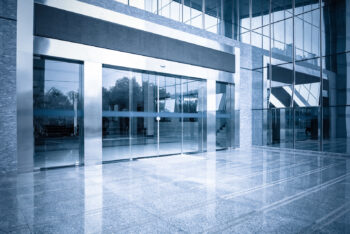 modern office building gate entrance and automatic glass door with blue tone